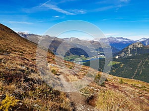 Trail for hiking or mountain biking enduro ride at Davos with view of lake of Davos, at autumn time, grison, Switzerland