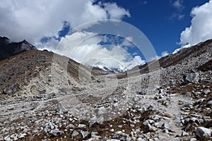 Trail in the Lobuche valley with big clouds and blue sky, Everest Base Camp trek, Nepal