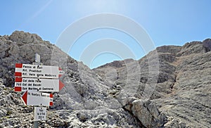 Trail marker in the mountain path with place in italian language photo