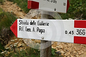 Trail marker with text of italian location in mountains photo