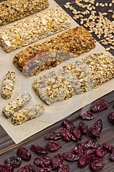 Trail mix, Cereal granola bars, raisins on wooden background