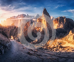 Trail in mountain valley at colorful sunset in summer in Italy