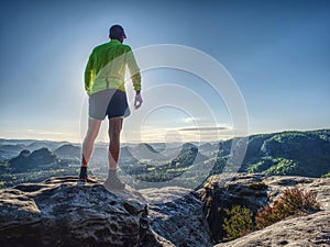 Trail runner athlete man. Slim person training in mountains