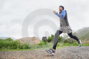 Trail, runner and man running in nature training, cardio exercise and endurance workout for wellness. Sports, fitness or