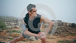 Trail runner prepare workout in nature park closeup. Focused athlete stretching