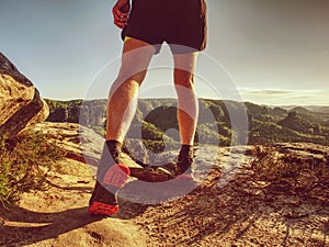 Trail runner in natural terrain, body contour in low ankle view photo