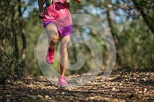 Trail runner running in forest trail