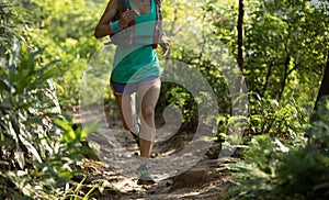Trail runner running in morning forest