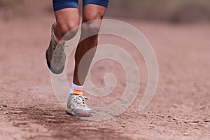 Trail runner running in summer mountain nature landscape on difficult path in mountains