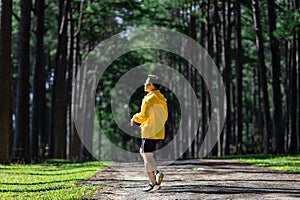 Trail runner is stretching for warm up outdoor in the pine forest dirt road for exercise and workout activities training for