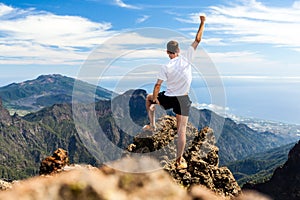 Trail runner success, man running in mountains photo
