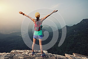 Trail runner woman open arms at great wall