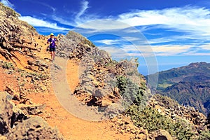 Trail runner woman, walking in mountains