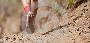 Trail running action close up of running shoes