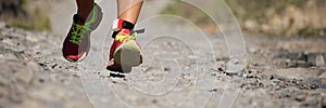 Trail running action close up of running shoes