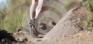 Trail running athlete exercising for fitness and health outdoors on mountain pathway