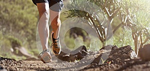 Trail running athlete exercising for fitness and health outdoors on mountain pathway