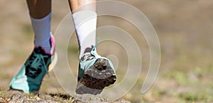 Trail running athlete exercising for fitness and health outdoors on mountain pathway