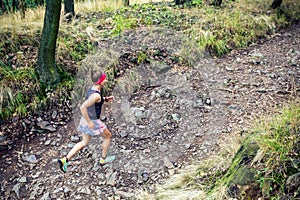 Trail running athletic woman in green forest, sports inspiration
