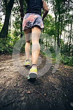 Trail running athletic woman in green forest, sports inspiration