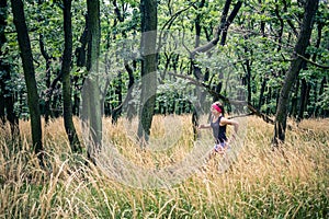 Trail running athletic woman in green forest, sports inspiration