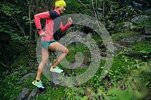 Trail running girl in green forest.