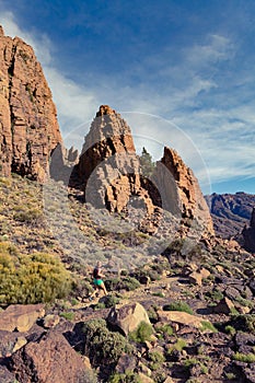 Trail running girl in mountains on rocky path