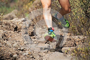 Trail running man on mountain path exercising