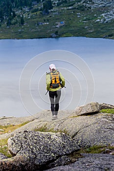 Trail running woman cross country in mountains on summer beautiful day