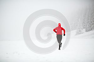 Trail running woman in winter mountains