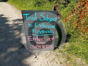 trail subject to flooding sign on trail or path