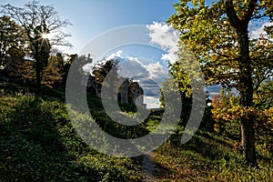 Trail to medieval castle ruin Homburg, fall landscape, sunstar in tree