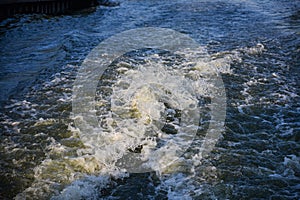 Trail on water surface behind of fast moving motor boat