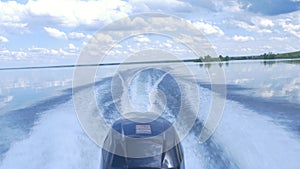 Trail on water surface behind of fast moving motor boat. the motor of motor boat, back view. Sea water ship trail with