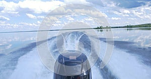 Trail on water surface behind of fast moving motor boat. the motor of motor boat, back view. Sea water ship trail with