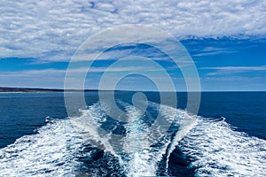 Trail on water surface behind of fast moving motor boat, Western Australia