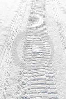 Trail of wheel in fresh snow photo