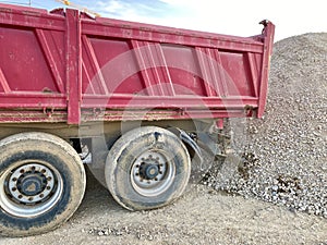 Trailer against a large gravel mound