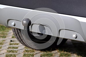 Trailer coupling on a silver-coloured car with reverse warning devices photo