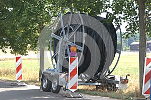Trailer with a large cable drum used for telecommunications