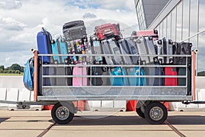 Trailer on airport filled with suitcases