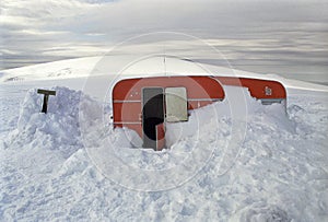 Trailer partly buried in snow