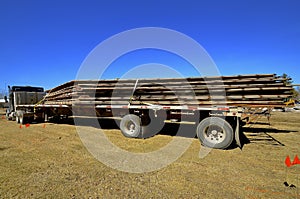 Trailer of salvaged wooden rafters