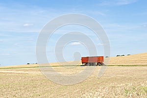 Trailer standing on a harvested field