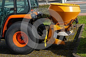 Trailer on a tractor for spreading road salt on icy sections of the road.