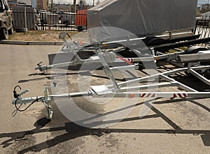 trailer for transporting boats yachts. stands on the street. travel and cargo transportation concept