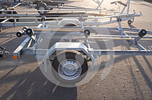 trailer for transporting boats yachts. stands on the street. travel and cargo transportation concept