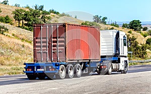 trailer transports container on highway