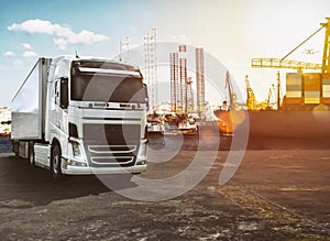 Trailer truck on the dock of a commercial port at sunset