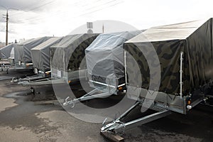 trailers with a covered awning stand on the street. travel and cargo transportation concept